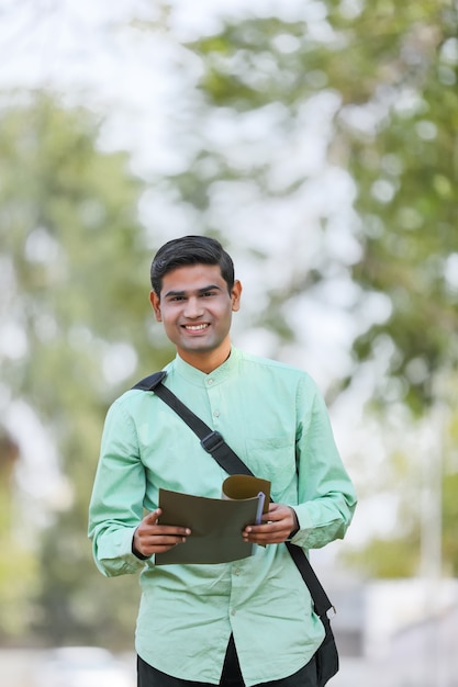 Young indian college student or job seeker holding file in Hand.