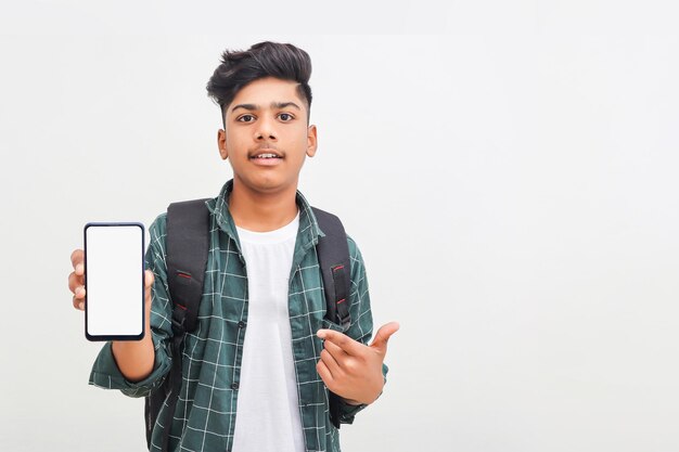 Young indian college student showing smartphone Screen on white background.