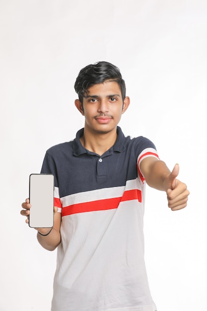 Young indian college student showing smartphone Screen on white background.