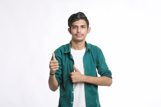 Young indian college student showing thumps up.