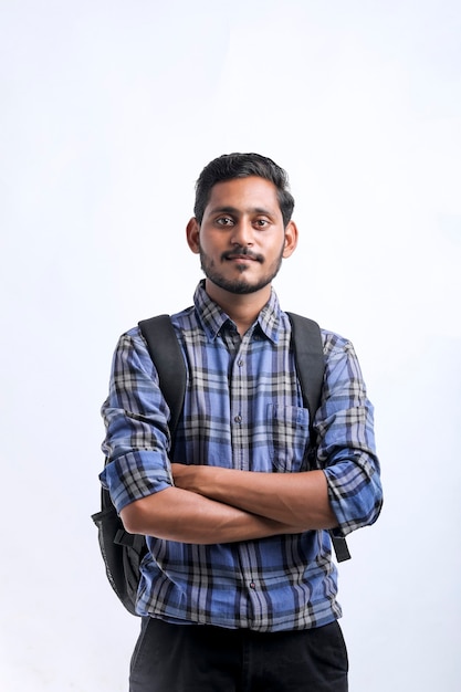 Young indian college student with bag pack on white background.