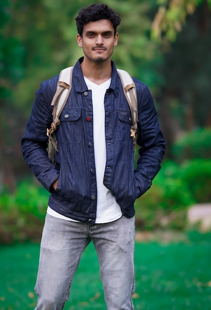 Young indian college student with green background