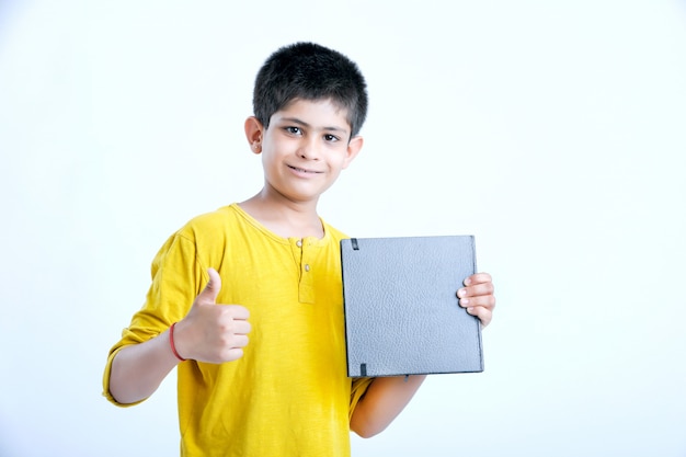 Young indian cute boy with notebook