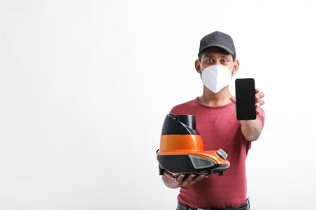 Young indian electrician showing smartphone with mixer