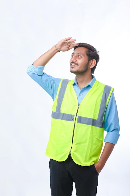 Young Indian engineer giving expression on white background.