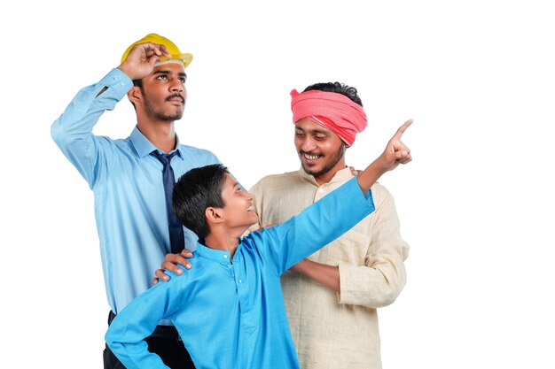 Young indian engineer with farmer and his child on white background.