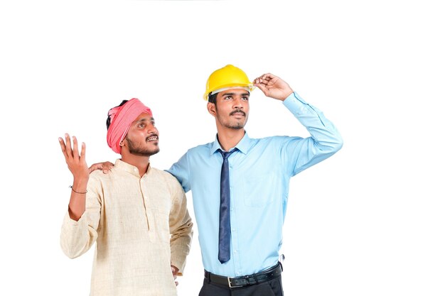 Young indian engineer with farmer on white background.