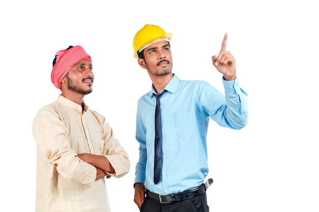 Young indian engineer with farmer on white background.