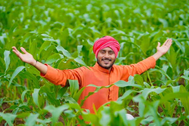 Young indian farmer at corn field.