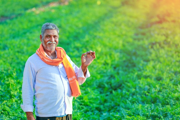 Young indian farmer at field