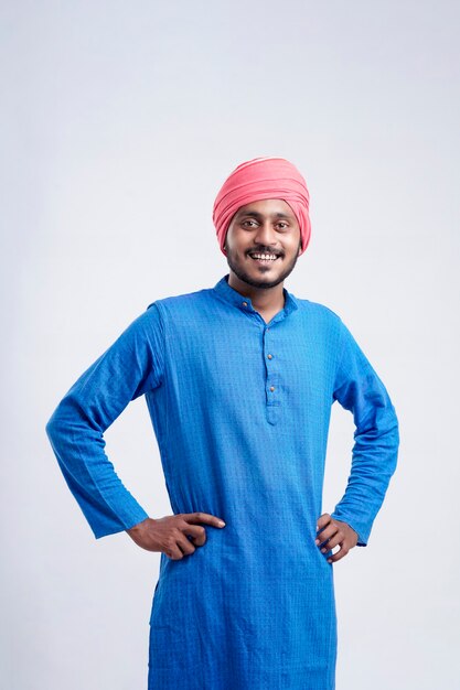 Young indian farmer giving expression on white background.