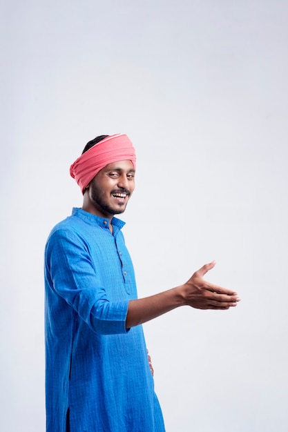 Young indian farmer giving expression on white background.