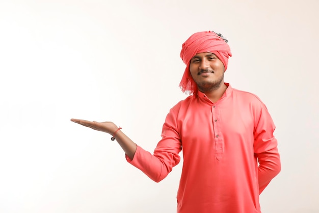 Young indian farmer giving expression on white background.