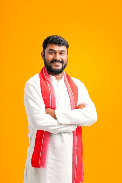 Young indian farmer giving expression on yellow background