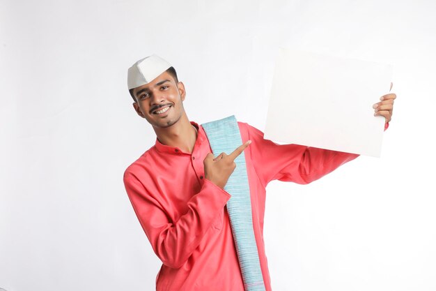 Young indian farmer holding white card board on white background.