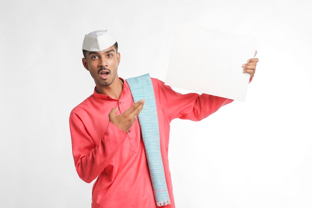 Young indian farmer holding white card board on white background.