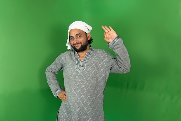 young indian farmer okay symbol on left hand with smiling and looking at camera isolated copy space