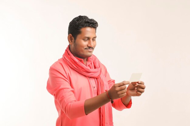 Young indian farmer showing card on white background.