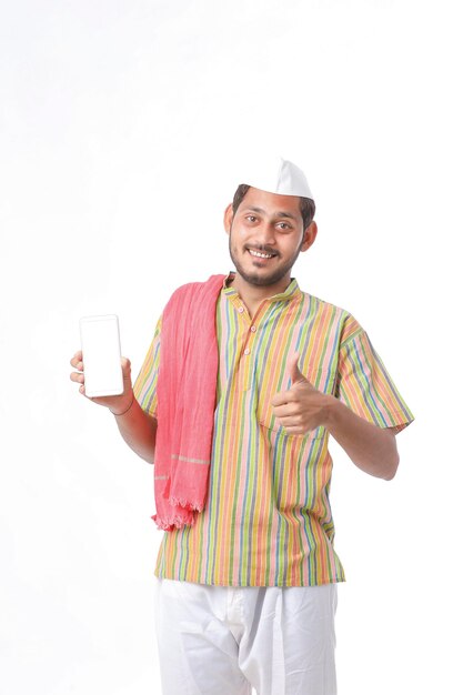 Young indian farmer showing smartphone on white background.