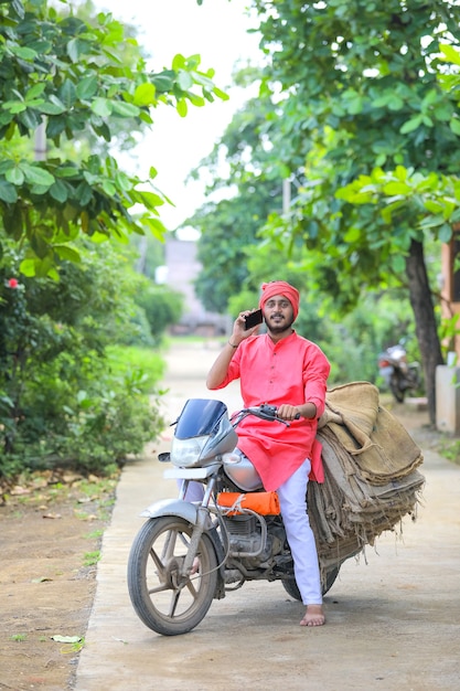 Young indian farmer talking on mobile phone