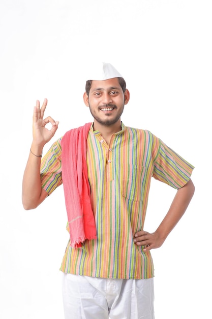 Young indian farmer in traditional wear and giving expression on white background.