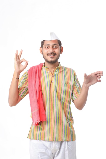 Young indian farmer in traditional wear and giving expression on white background.