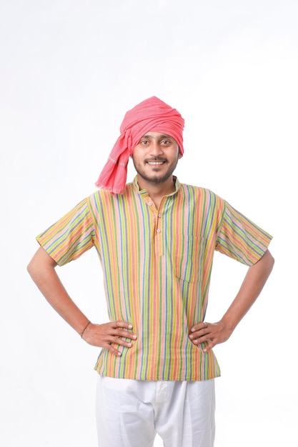 Photo young indian farmer in traditional wear and giving expression on white background.