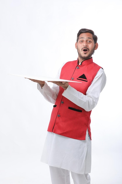 Young indian farmer in traditional wear and giving expression on white background.