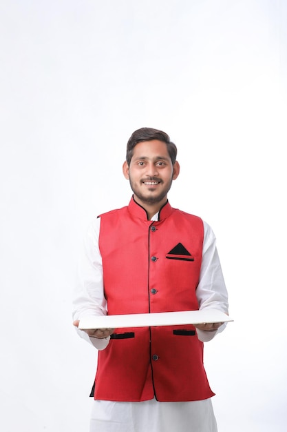 Young indian farmer in traditional wear and giving expression on white background.