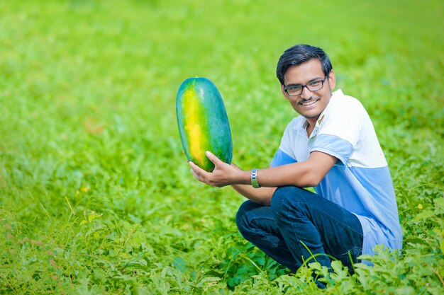 Young indian farmer at watermelon field