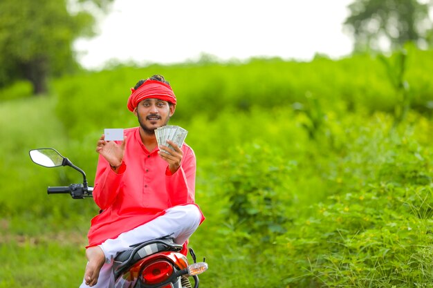 Young indian farmer with money and credit card