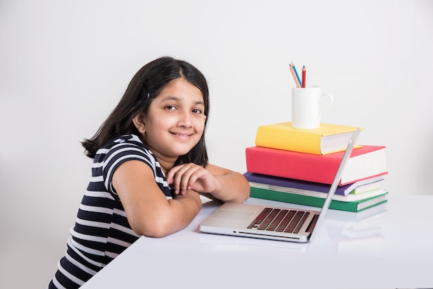 A young Indian girl is attending online school or classes. Study in lock down as Schools closed due to Covid-19. Role of technology during nationwide lock down. Learning at home concept in India