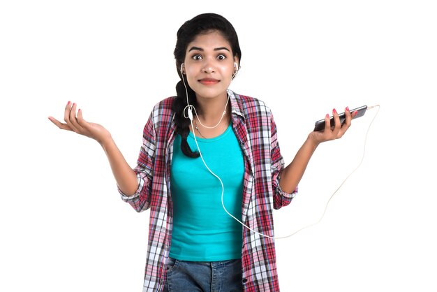 Young Indian girl using a mobile phone or smartphone isolated