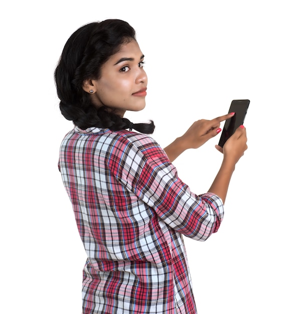 Young Indian girl using a mobile phone or smartphone isolated