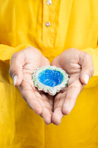 Young Indian Guy Holding Diya for Diwali and wearing traditional