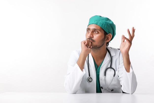 Young indian male doctor showing expression at clinic.