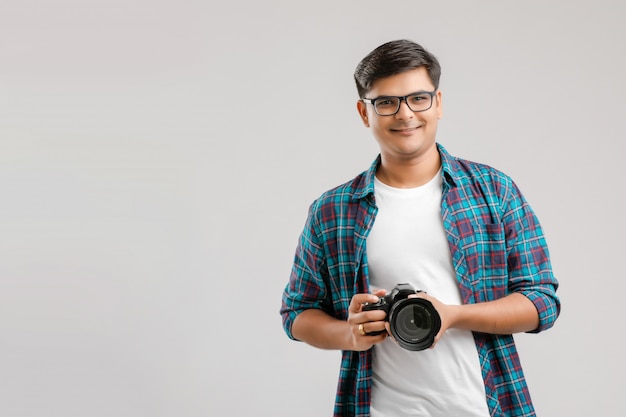 Young Indian man capturing photo with camera