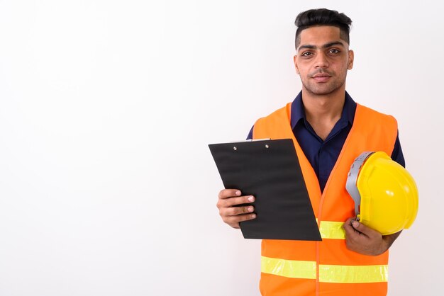 Young Indian man construction worker on white