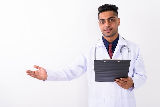 Young Indian man doctor on white