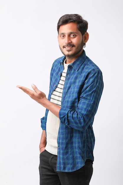 Young indian man giving expression on white background.