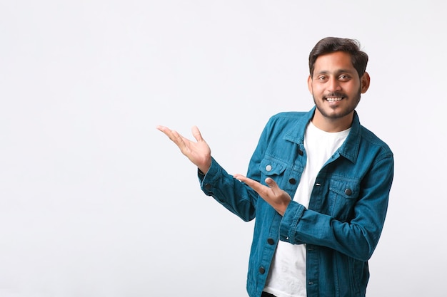 Young indian man giving expression on white background.