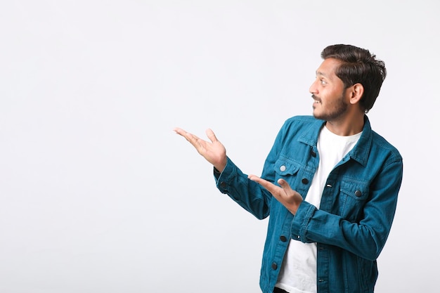 Young indian man giving expression on white background.