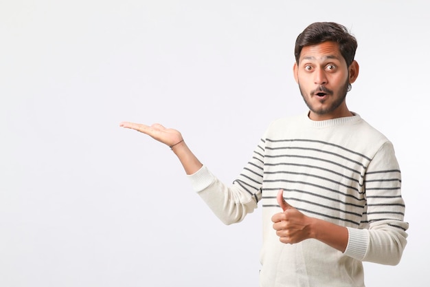 Young indian man giving expression on white background.