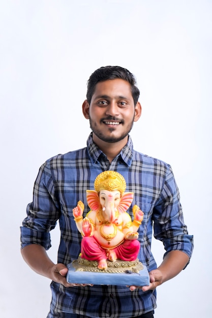 Young indian man holding goddess sculpture and celebrate festival.