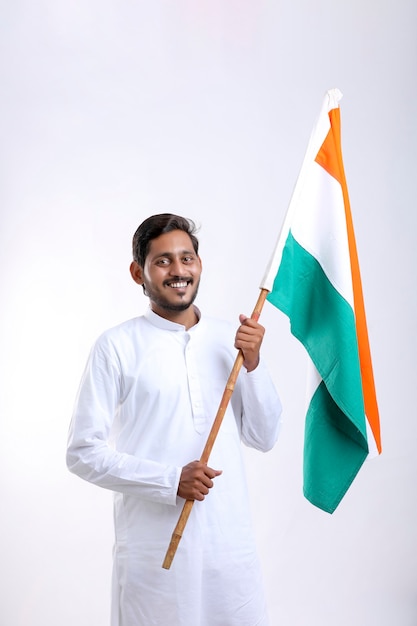 Photo young indian man holding indian national flag in hand over white background