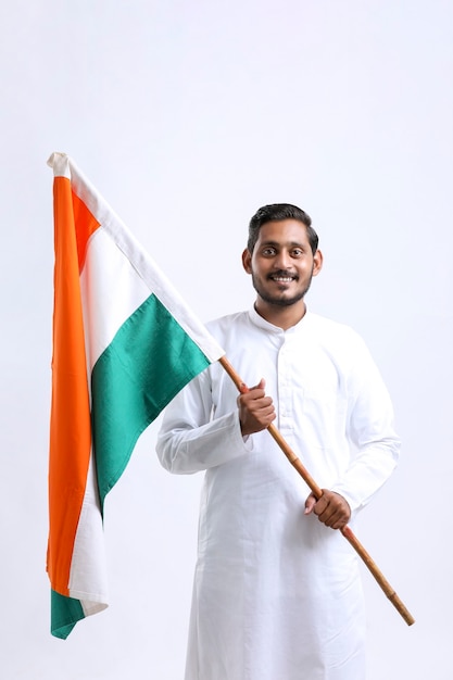 Young indian man holding indian national flag in hand over white background