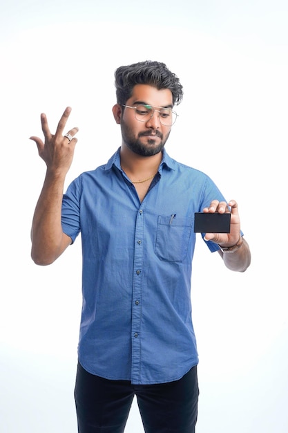 Young Indian man showing blank card