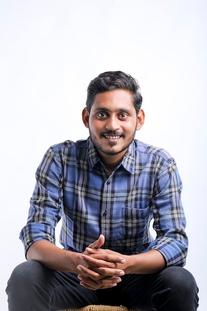 Young indian man showing expression on white background.