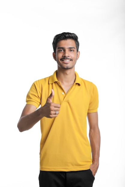 Young indian man showing expression on white background.