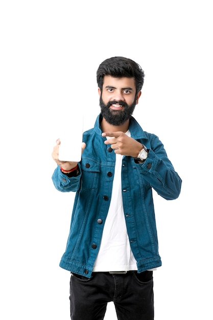 Young indian man showing smartphone screen on white background